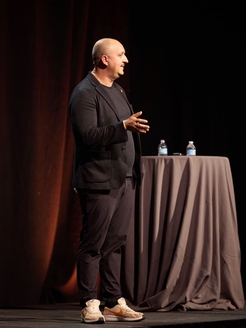 James Poulter delivering an AI keynote speech on stage