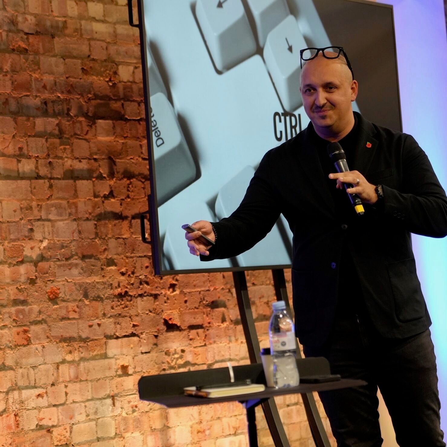 James Poulter presenting Control-Alt-Delete keynote with CTRL and Delete keys on screen
